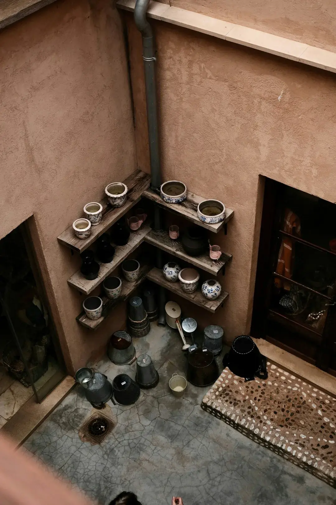 Wooden drying racks lined with pale unfired pots