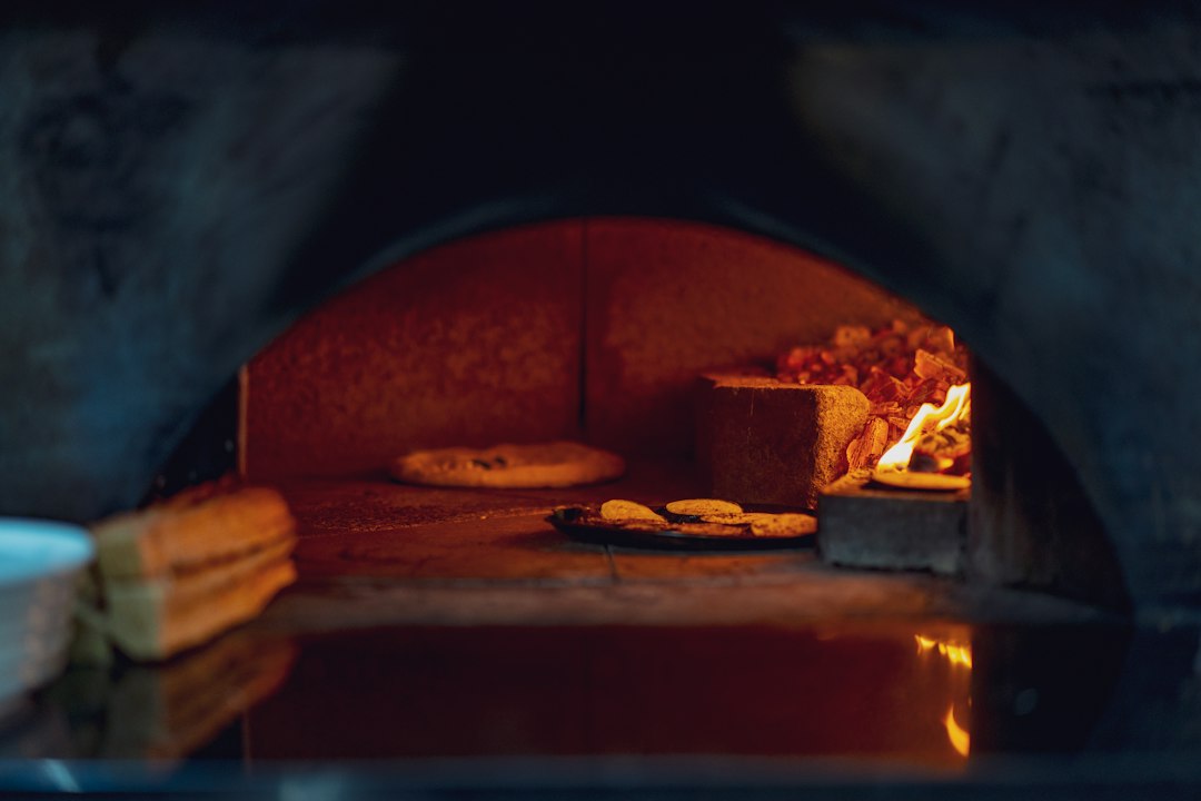 An open electric kiln stacked with bisque-fired ceramics