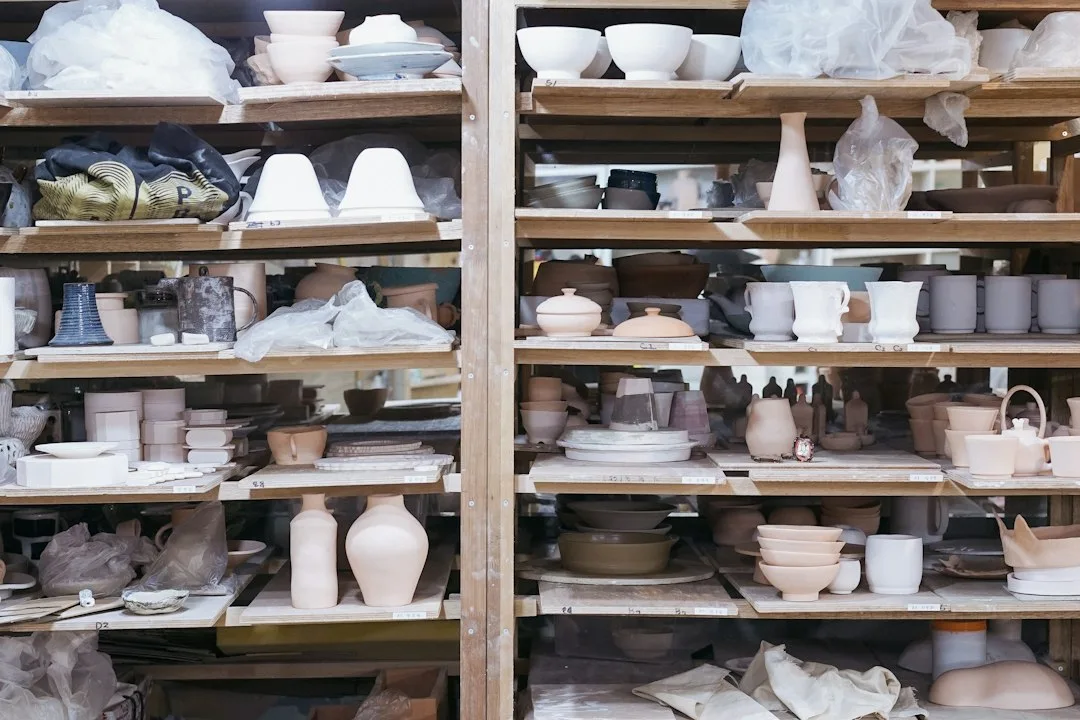 Wooden studio shelves holding members' drying pots and tools